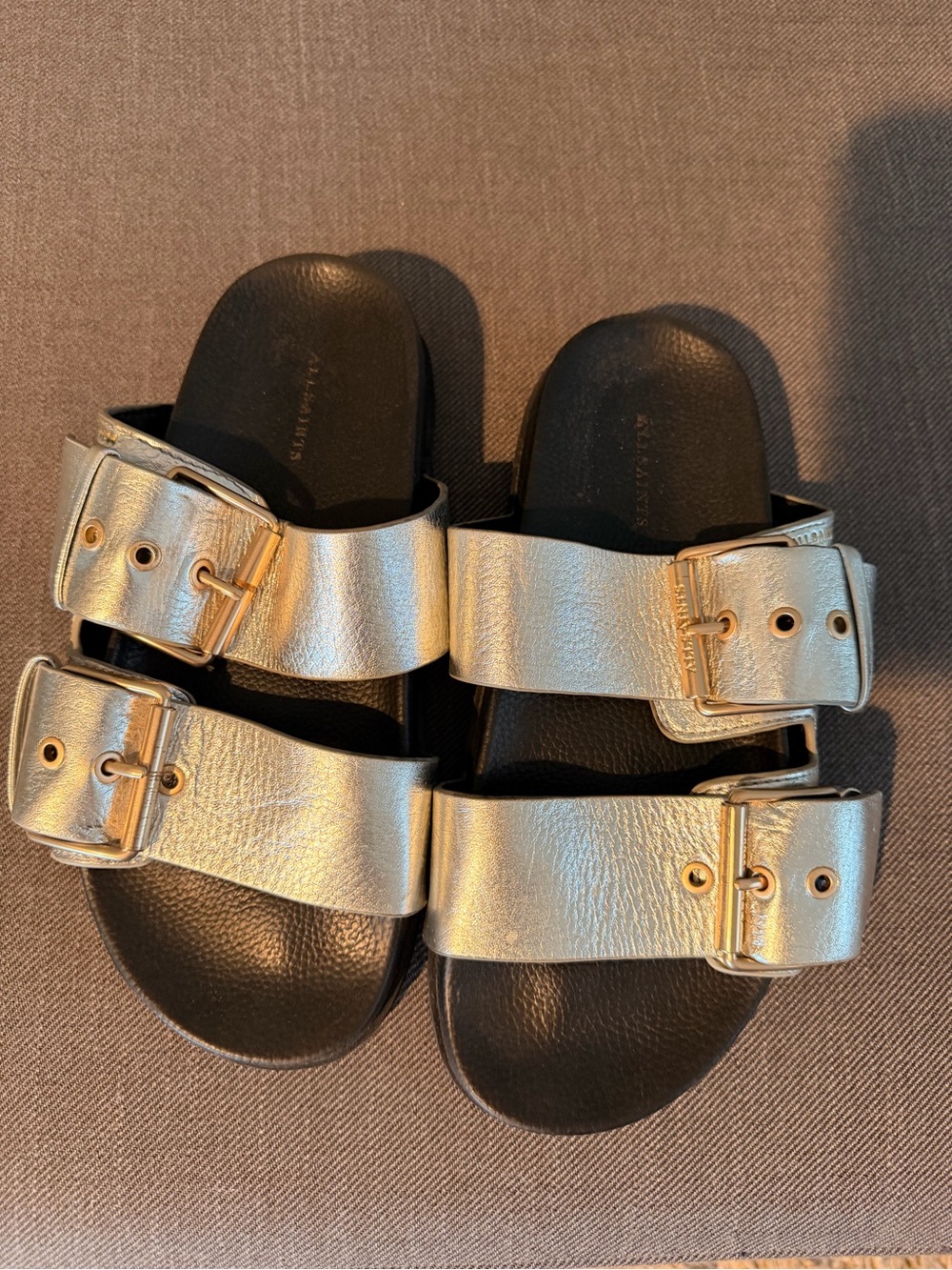 Silver All Saints Size 38 buckle sandal. Leather upper. Rubber bottom.